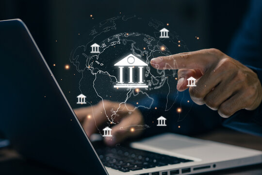 Business professional using a laptop with virtual global bank icons, representing digital banking, financial technology, online transactions, global finance, and financial services.