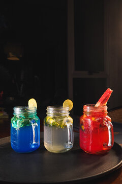 Refreshing and colorful healthy cool drinks served with fresh lemon slices and watermelon garnish. A vibrant summer beverage concept representing freshness, hydration, natural ingredients, healthy lif