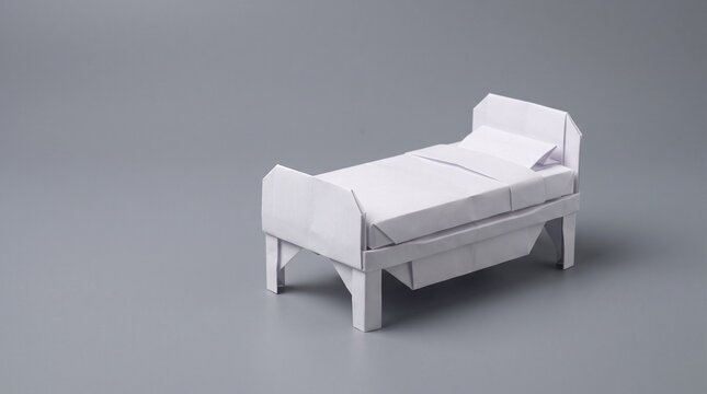 Minimalist white hospital bed with side railings positioned on neutral studio background