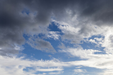 Fototapeta premium Dramatic dark storm cloud in blue and gray sky before heavy rain, nature landscape