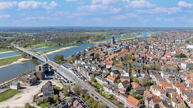 Aerial view of the historic city of Deventer with the Lebuinuskerk church, the Wilhelminabrug bridge crossing the IJssel river, and traditional rooftops in Deventer, Overijssel, Netherlands.