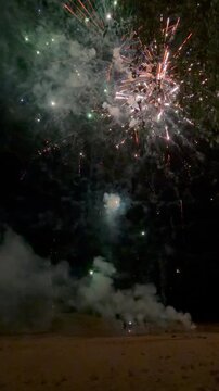 a festive and dramatic atmosphere over a sandy outdoor field with firework