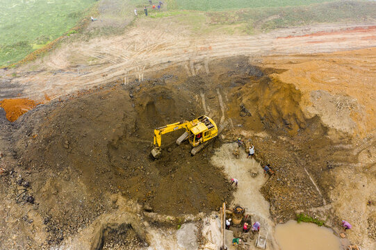 Aerial view of an excavator working at an excavation site in Aminbazar, Dhaka Division, Bangladesh.