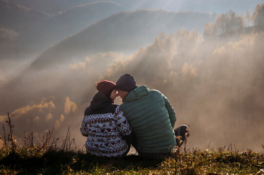 Happy couple in autumn morning lanscape.