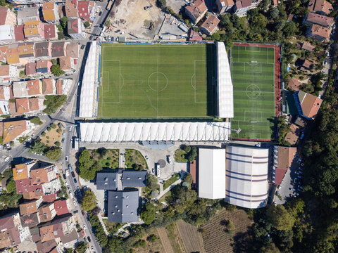 Aerial view of Yusuf Ziya Onis Stadium with its green pitch and surrounding residential buildings in Sariyer, Istanbul, Turkey.