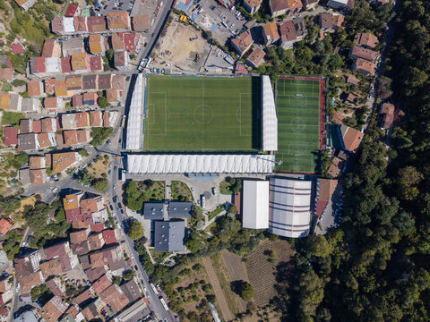 Aerial view of Yusuf Ziya Onis Stadium surrounded by residential buildings and greenery in Sariyer, Istanbul, Turkiye.