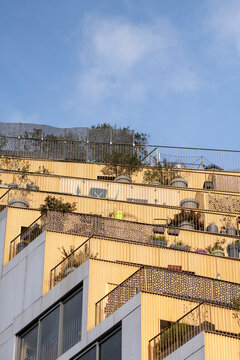Contemporary apartment building with terraces and rooftop on a residential facade in Paris France showing contemporary apartment architecture