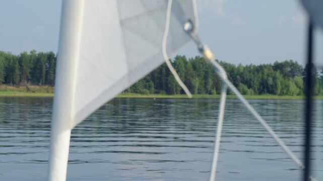 Detail of the sailing boat moving on the lake