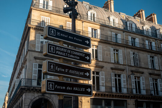 Street signs indicating direction to bourse de commerce, eglise saint-eustache, forum des halles in paris