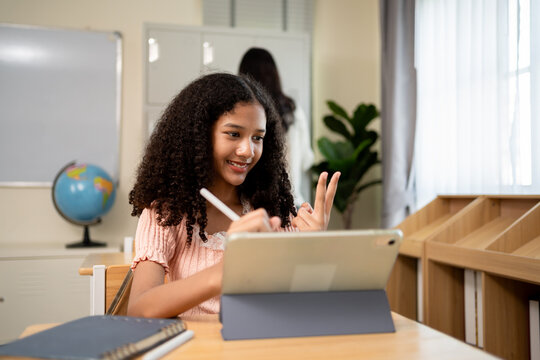 African American schoolgirl learning in classroom at elementary school. 