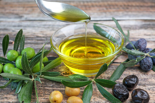 organic olive oil pouring in a glass bowl	