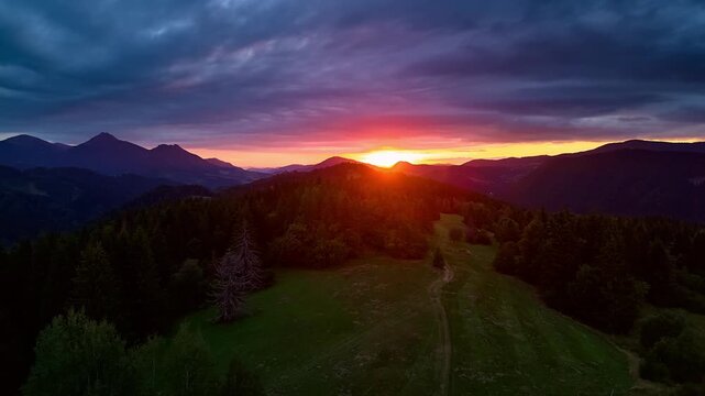 Aerial Hyperlapse Flying Forward Above Mountain Forest Towards Golden Sunset