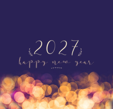 handwriting 2027 happy new year on vintage blur festive bokeh light background,holiday greeting card.