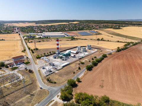 Aerial view of gas power plant and substation in rural Hungary with lines