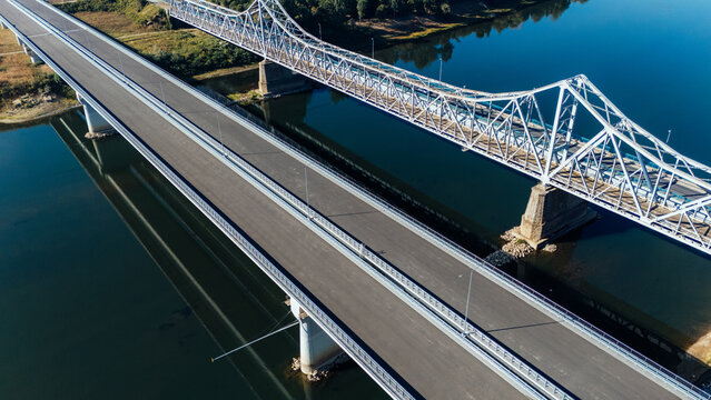 Aerial view of the Racha Bridge crossing the Sava River, showing the modern highway bridge alongside the historic steel truss bridge in Sremska Raca, Vojvodina, Serbia.