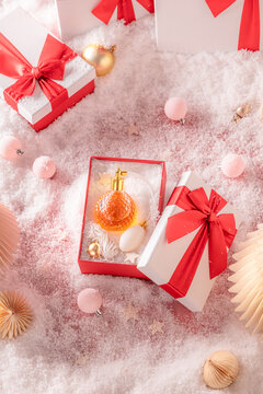 Strong perfume is wrapped up tightly inside Christmas gift box.
