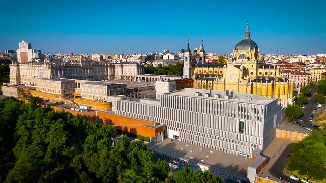 Almudena Cathedral and Royal Palace dominate Madrid city center under clear daylight; ideal for Spain travel, tourism, architecture and destination advertising