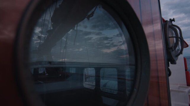 Sailing boat sails in the sea at twilight. Details of the sailing boat