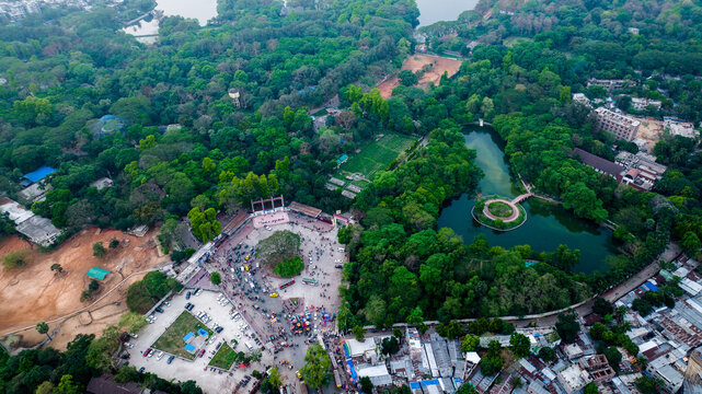 Aerial view of the lush green landscape of the Dhaka Zoo and Botanical Garden, featuring a pond, a central plaza, and urban structures in Dhaka, Dhaka Division, Bangladesh.