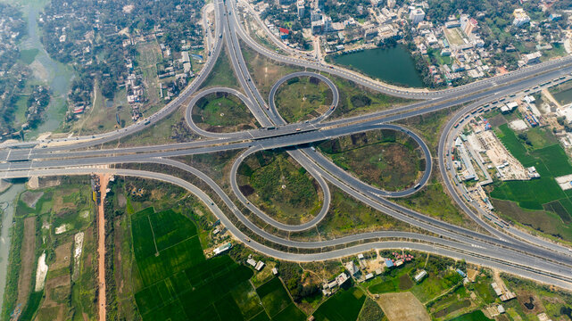 Aerial view of the complex highway interchange surrounded by lush green agricultural fields and rural landscape in Narail, Khulna Division, Bangladesh.