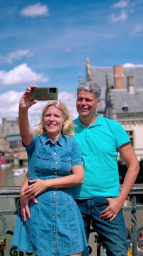 Happy mature couple taking a selfie in Ghent