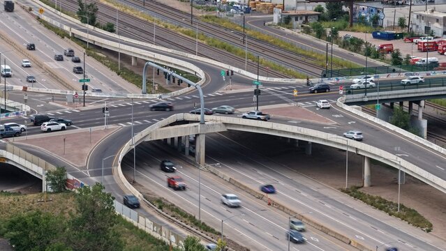 Aerial view of a complex highway interchange with multiple lanes, overpasses, and moving traffic in Englewood, Colorado, United States.