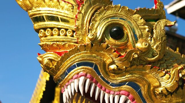 Slow Motion Close-Up of a Golden Naga Statue at a Traditional Thai Temple