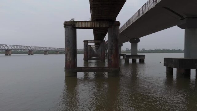 Aerial view of bridge support pillars standing in river water in Bharuch, Gujarat, India