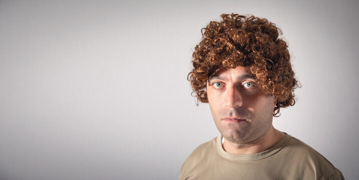 Caucasian young man wearing wig.