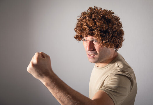 Caucasian young man wearing wig.