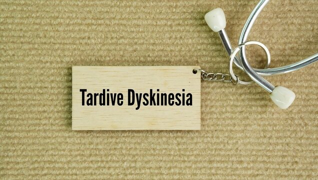 Stethoscope and paper tag with the words Tardive dyskinesia TD. neurological disorder that causes repetitive, involuntary body movements, most often triggered by long-term use of antipsychotic 