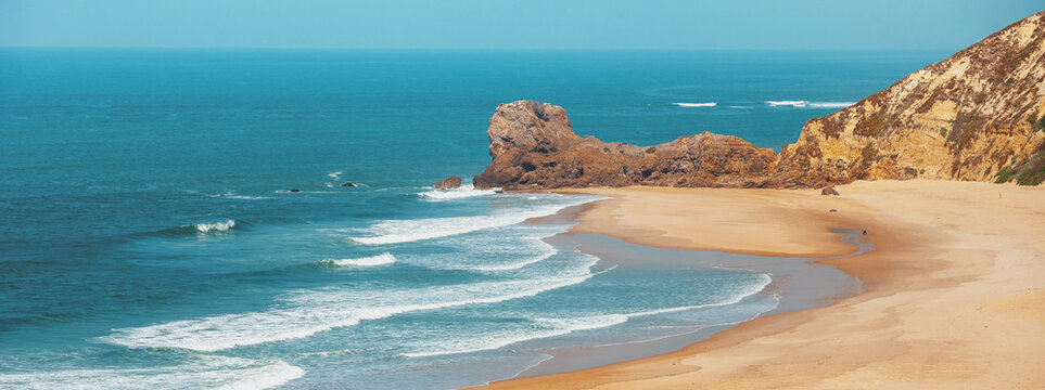 Seascape. Rocky sea shore on a sunny day. Paredes da Vitoria Beach, Portugal, Europe
