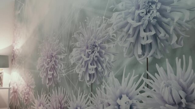 Abstract flower wallpaper design featuring multiple blooming dahlia or chrysanthemum flowers in soft pastel colors, creating a gentle pattern