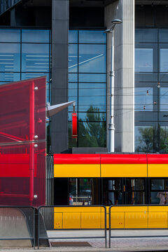 Detail of a yellow tram beside office buildings in the financial district of Warsaw Poland showing urban transport and business architecture