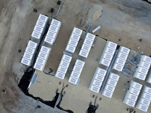 Aerial view of large BESS battery storage facility layout with rows of battery energy storage units under construction