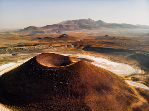 Aerial view of Lake Meke volcanic crater with its central cone and surrounding arid landscape in Karapinar, Konya, Turkiye.