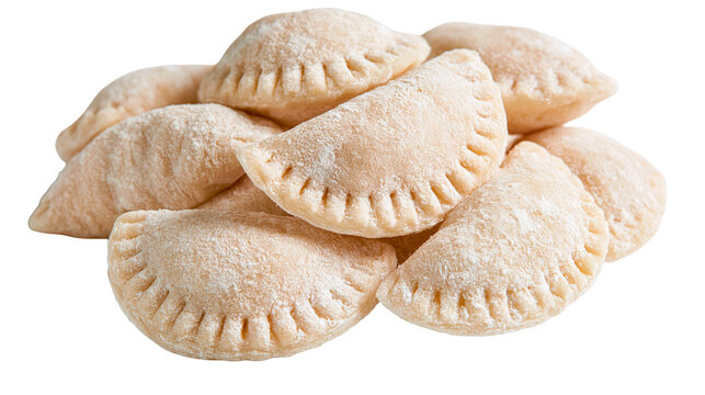 Raw uncooked flour dusted crescent shaped dumplings or pierogi