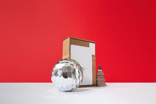 Christmas Gift Box Mockup with Silver Bauble on Red Background