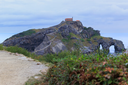 San juan de gaztelugatxe islet in basque country, spain, featuring the historic hermitage, winding staircase, and dramatic natural rock arches by the cantabrian sea