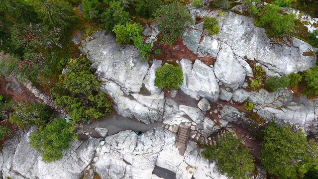 Aerial view of Ukko-Koli featuring rugged rock formations, lush pine trees, and stone stairs in Koli, Pohjois-Karjala, Finland.