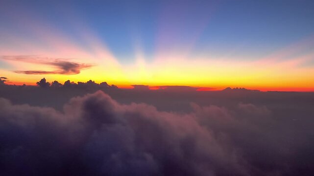 Stunning sunrise over a vast sea of clouds from high altitude perspective
