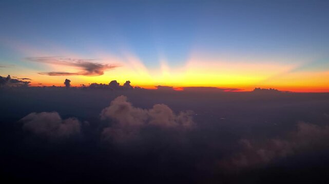 Aerial view of magnificent sunrise over sea of clouds with colorful sky
