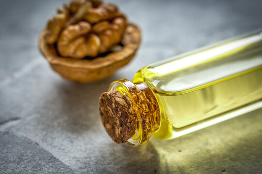 cosmetic and therapeutic walnut oil on gray background