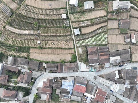 Aerial view of Merbabu View Cafe surrounded by terraced agricultural fields and traditional houses with tiled roofs in Kecamatan Getasan, Jawa Tengah, Indonesia.