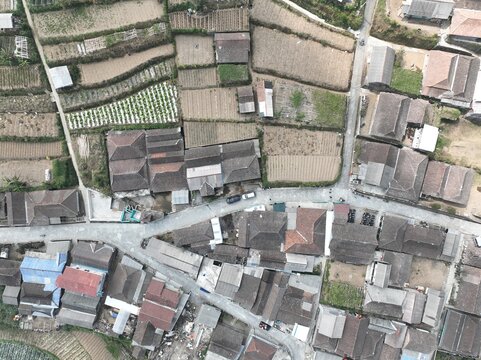 Aerial view of Merbabu View Cafe surrounded by traditional houses, terraced agricultural fields, and narrow village roads in Kecamatan Getasan, Jawa Tengah, Indonesia.