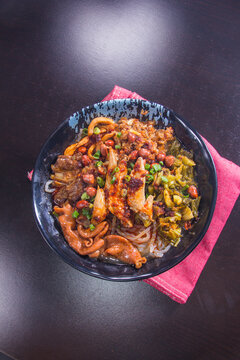 Delicious bowl of mixed dishes on a table with a red napkin