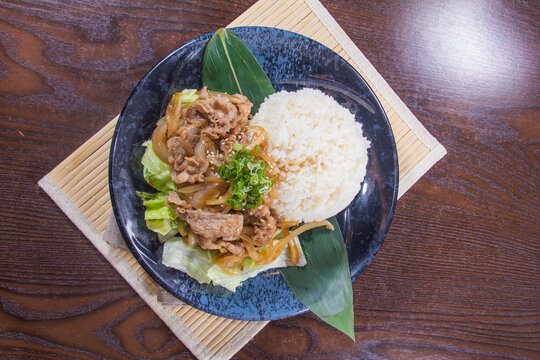 Delicious dish with rice and meat served on a plate with vegetables