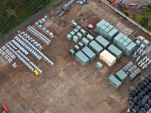 Aerial view of Mondo Power industrial site featuring rows of electrical transformers, power equipment, and storage containers on a paved yard in Ringwood, Victoria, Australia.