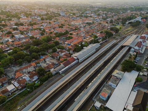 Aerial view of Stasiun Kejaksan with its railway tracks, platforms, and surrounding urban rooftops in Cirebon, West Java, Indonesia.