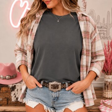 Cowgirl model in casual summer outfit. Western, southern woman in dark gray shirt with open plaid shirt over it, light blue frayed denim shorts. Howdy, country woman indoor mockup